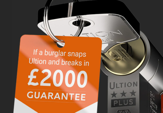 Key with a tag reading "£2000 Guarantee" for Ultion locks, promoting security assurance.